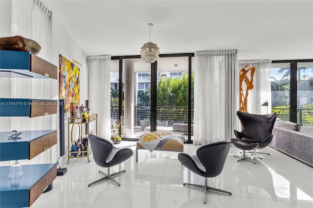 living area with plenty of natural light, tile patterned flooring, and expansive windows