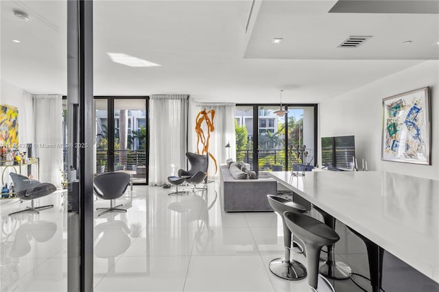 interior space with a wall of windows, french doors, visible vents, and light tile patterned flooring