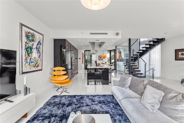 living area with recessed lighting, stairway, and light tile patterned floors