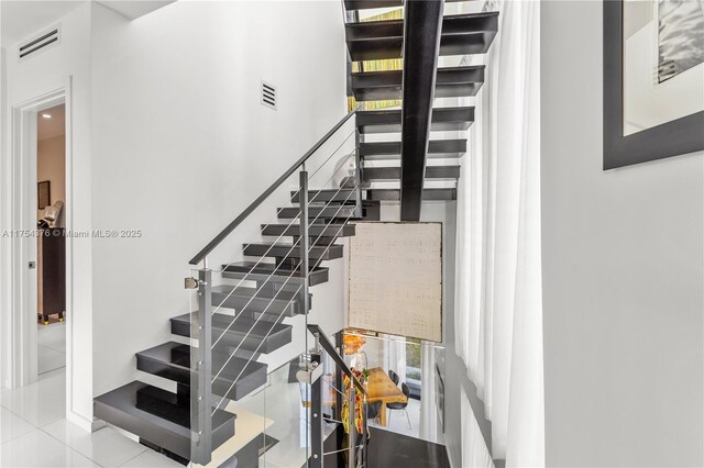 staircase with visible vents and tile patterned floors