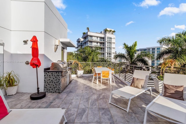 view of patio with a balcony, grilling area, area for grilling, and outdoor dining space