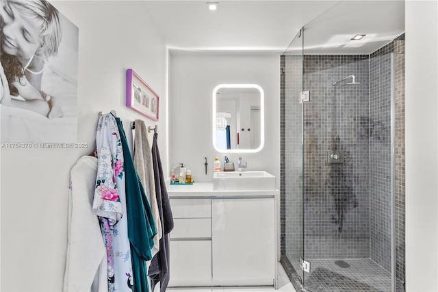 bathroom with a shower stall and vanity