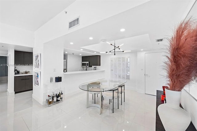 dining area with light tile patterned floors, visible vents, and recessed lighting