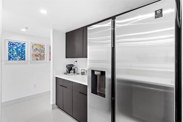 interior space with light countertops, stainless steel fridge, recessed lighting, and modern cabinets