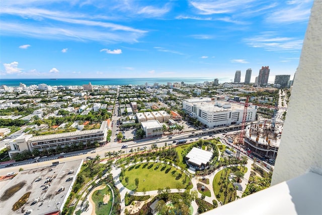 birds eye view of property featuring a water view and a view of city