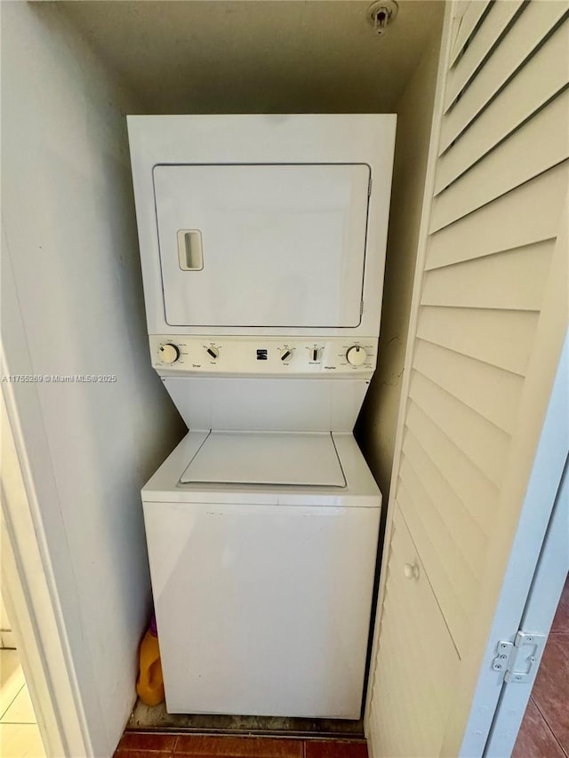 clothes washing area with laundry area and stacked washer / dryer