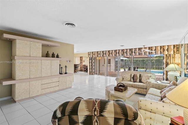 living room featuring visible vents and light tile patterned floors