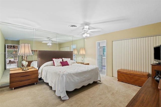 carpeted bedroom featuring ensuite bath, ceiling fan, and visible vents