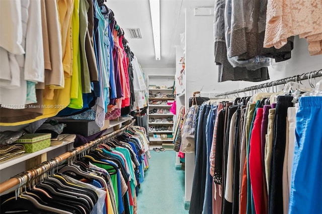 walk in closet featuring visible vents and carpet flooring