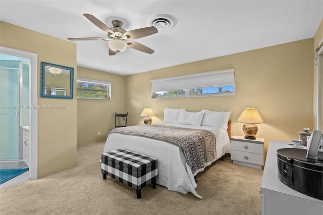 bedroom with ceiling fan, visible vents, and light colored carpet