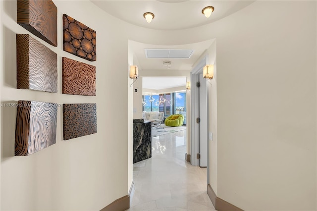 hallway with visible vents and baseboards