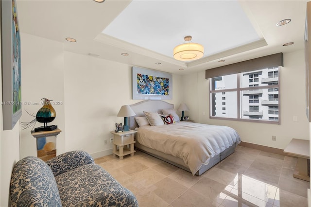 bedroom featuring recessed lighting, a raised ceiling, and baseboards