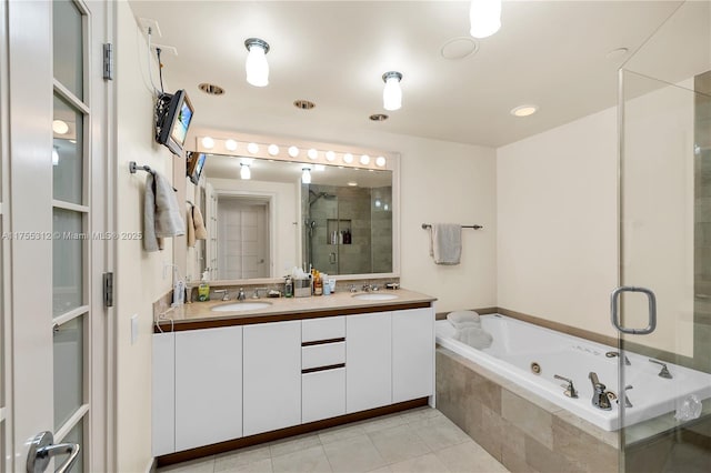 bathroom with double vanity, a stall shower, a sink, tile patterned flooring, and a tub with jets