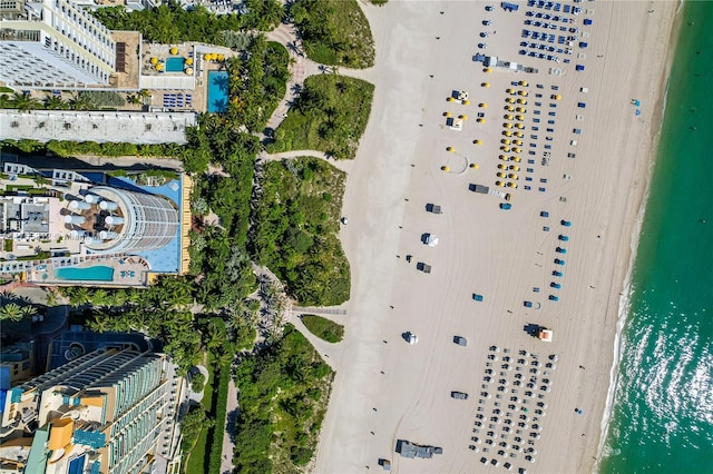 drone / aerial view featuring a water view and a beach view