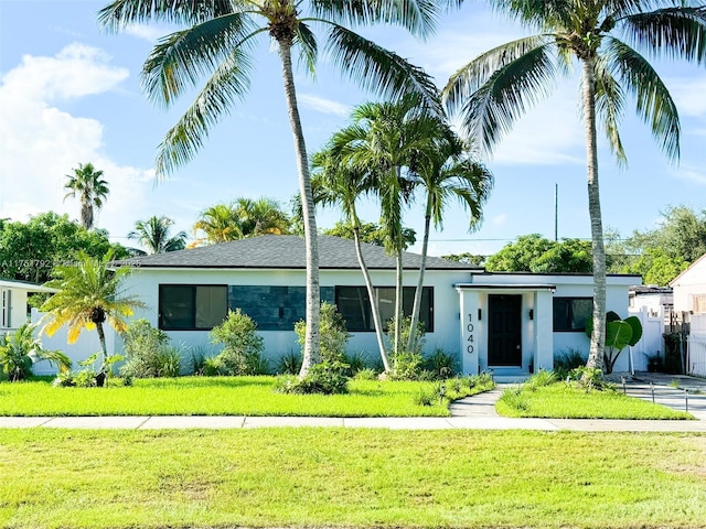 view of front of house featuring a front yard and stucco siding