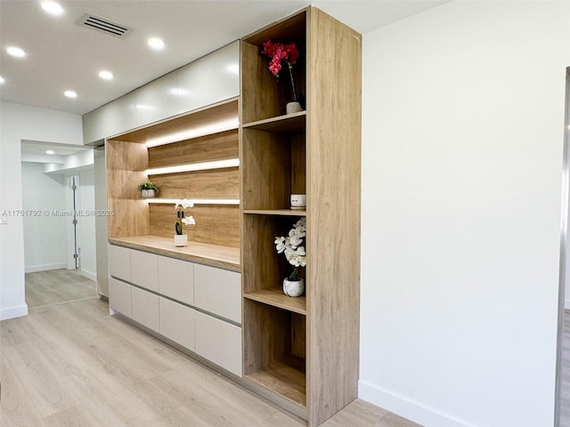 bathroom with recessed lighting, wood finished floors, vanity, baseboards, and visible vents