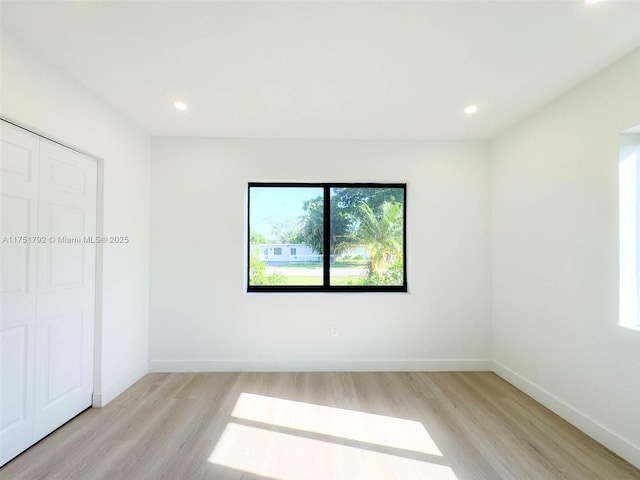 unfurnished bedroom with light wood finished floors, recessed lighting, and baseboards