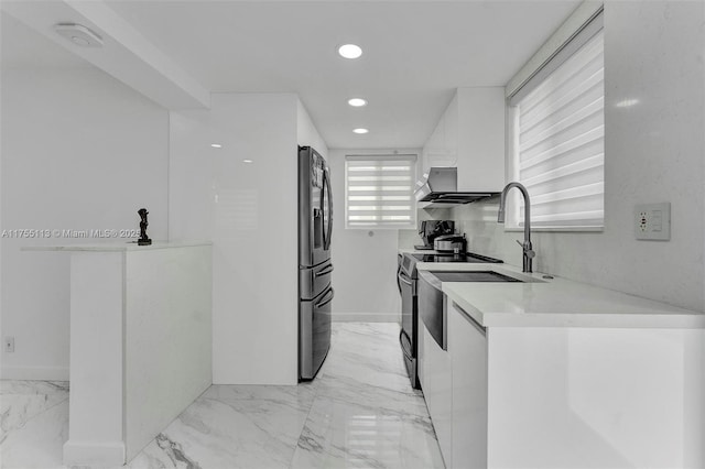 kitchen with marble finish floor, fridge with ice dispenser, white cabinetry, and light countertops