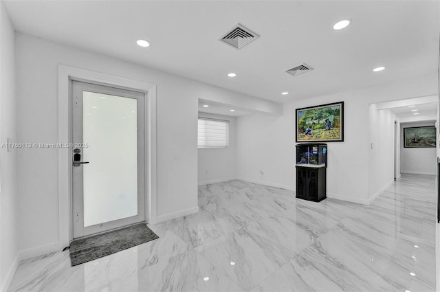 interior space with baseboards, marble finish floor, visible vents, and recessed lighting