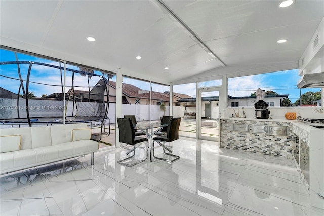 sunroom / solarium featuring lofted ceiling