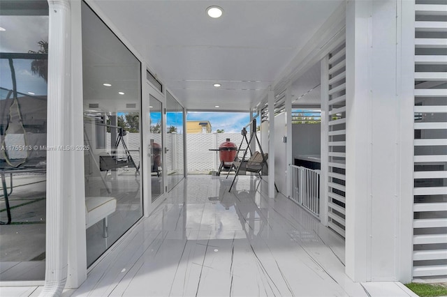 corridor featuring expansive windows and recessed lighting