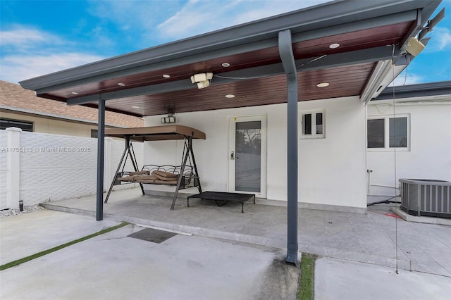 view of patio featuring fence and central AC