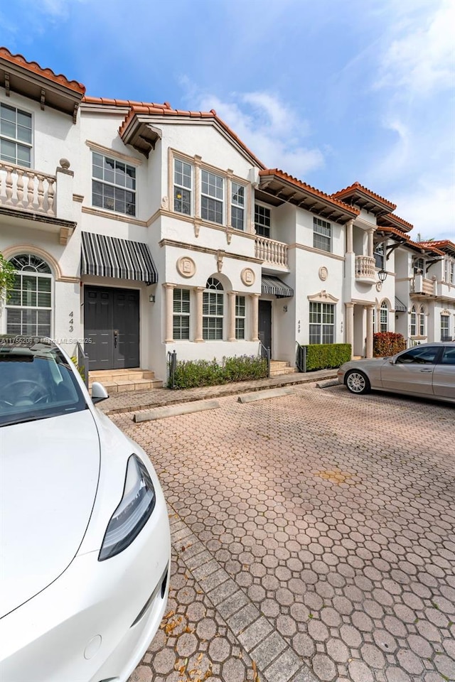 mediterranean / spanish home with a tile roof and stucco siding