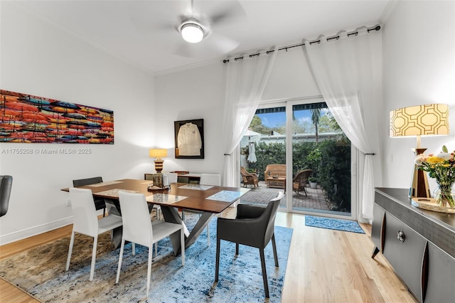 dining room with baseboards, crown molding, and light wood-style floors