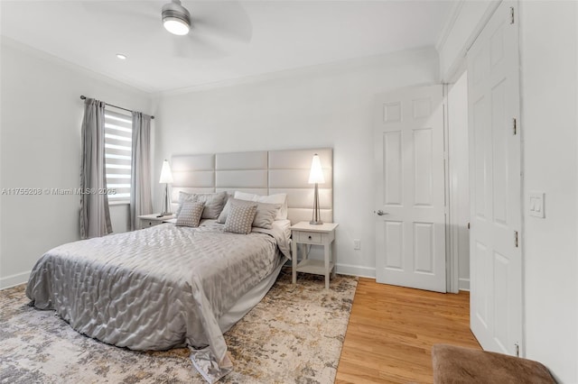 bedroom featuring baseboards, ceiling fan, wood finished floors, and crown molding