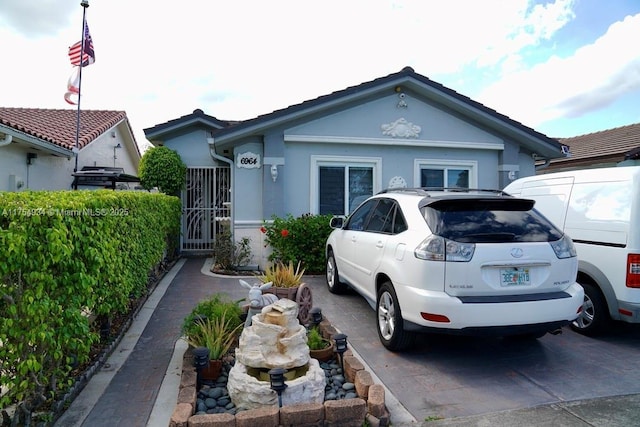 single story home featuring stucco siding