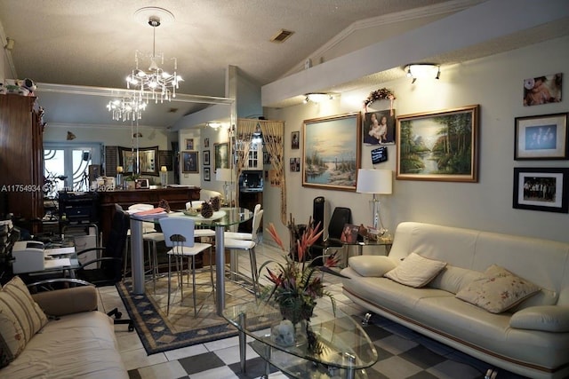 living area featuring lofted ceiling, visible vents, and a notable chandelier