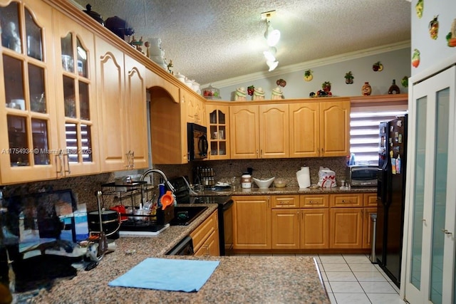 kitchen with lofted ceiling, a textured ceiling, crown molding, black appliances, and light tile patterned flooring