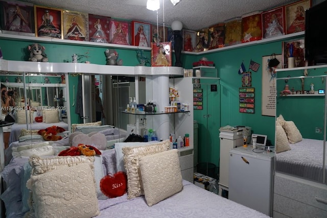 interior space featuring a textured ceiling and fridge