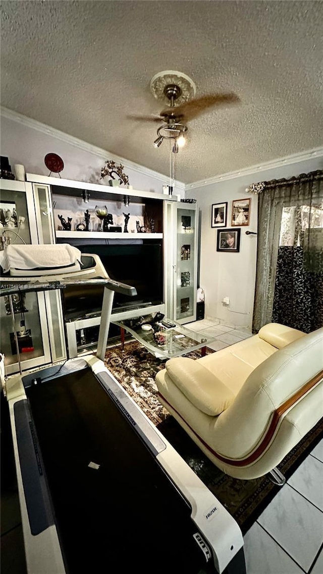 bedroom with ornamental molding, ceiling fan, and a textured ceiling