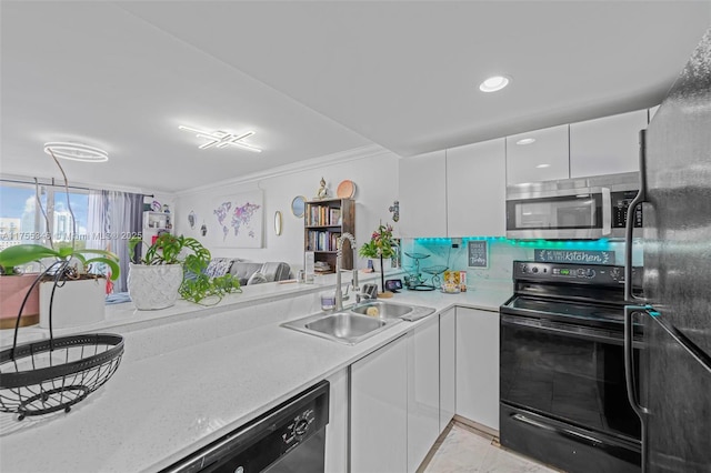 kitchen featuring light countertops, white cabinets, a sink, modern cabinets, and black appliances