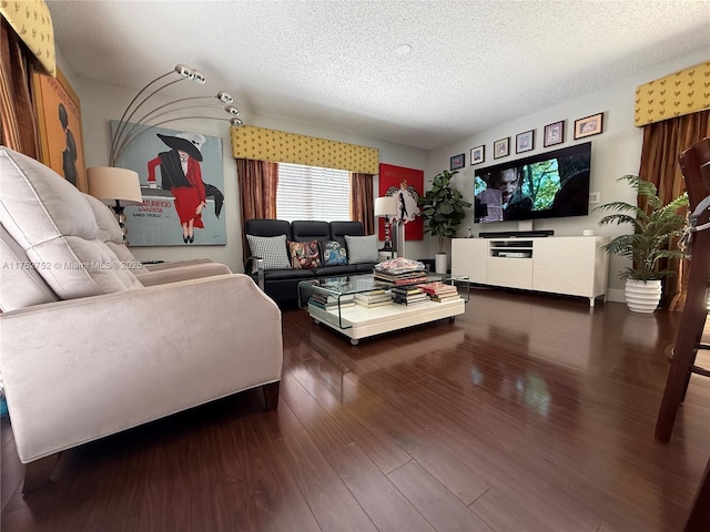 living area with a textured ceiling and wood finished floors