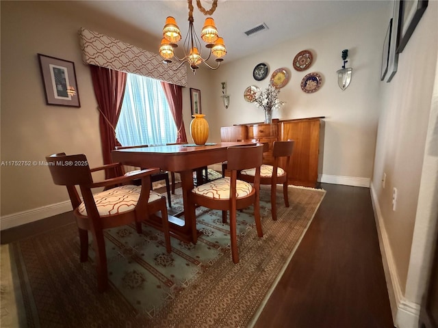 dining room with baseboards, visible vents, and a notable chandelier