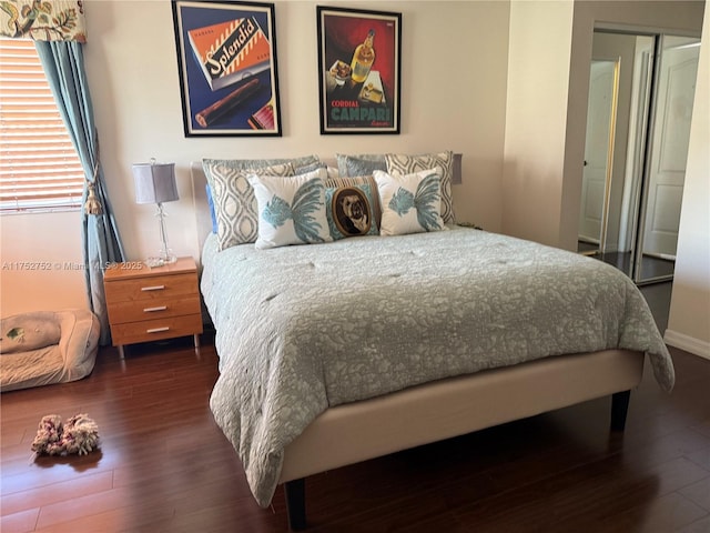 bedroom featuring dark wood-style floors and a closet