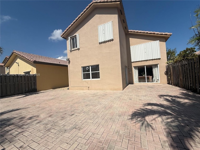 back of property with a patio area, fence, and stucco siding