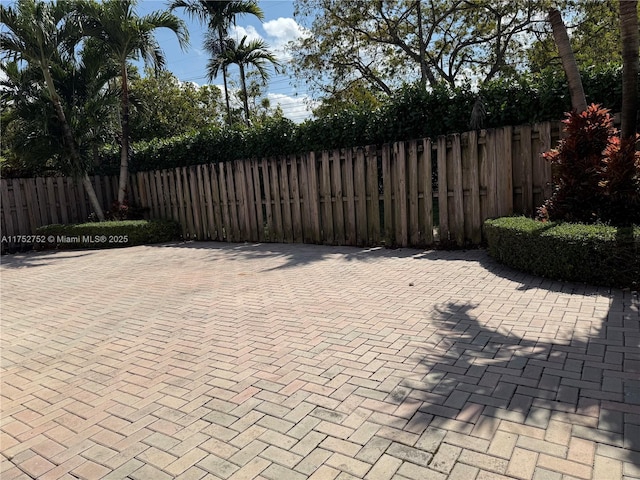 view of gate with a patio area and fence