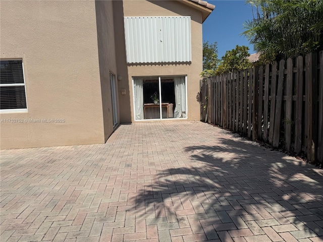 view of patio featuring fence