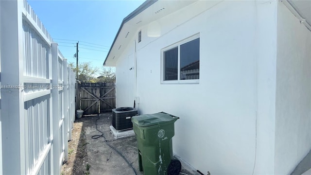 view of side of property featuring fence and cooling unit