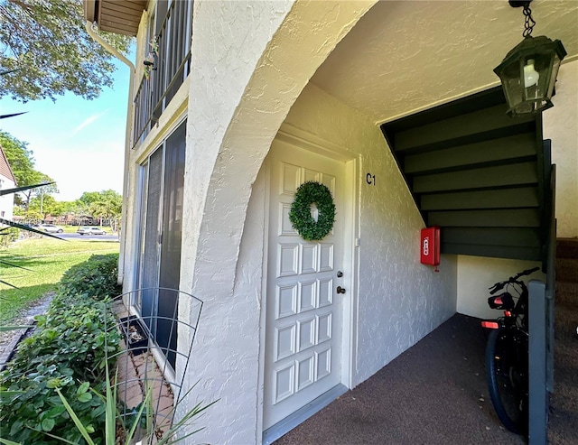 property entrance with stucco siding