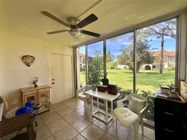 sunroom / solarium featuring a ceiling fan