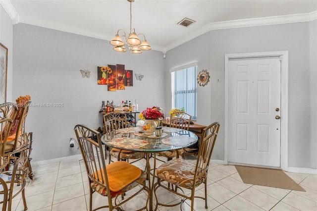 dining room with ornamental molding, visible vents, an inviting chandelier, and light tile patterned floors