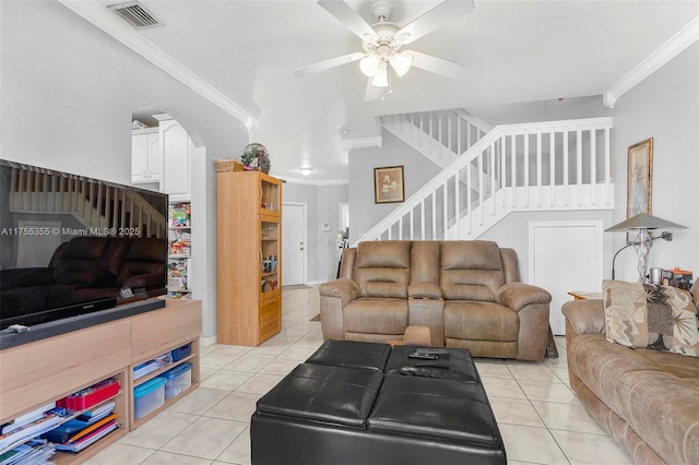 living room featuring ornamental molding, light tile patterned floors, visible vents, and stairs