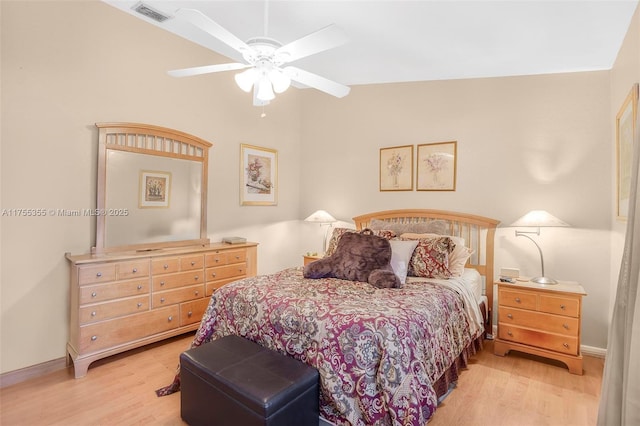 bedroom with ceiling fan, wood finished floors, visible vents, and baseboards