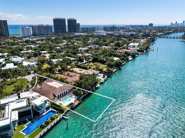 birds eye view of property with a view of city and a water view