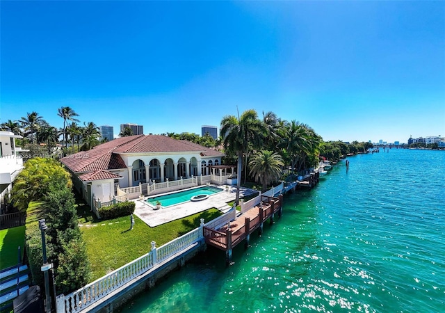 view of dock featuring a patio, fence, a fenced in pool, a yard, and a water view