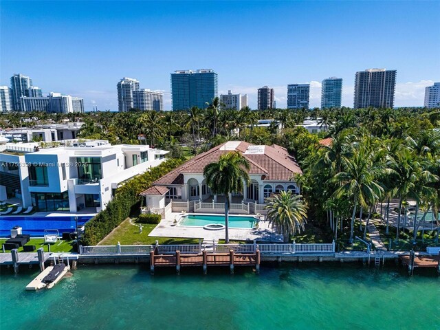 birds eye view of property with a city view and a water view